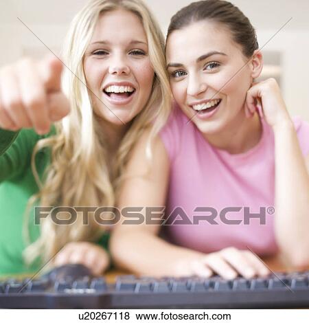 Stock Photo - Two teenage girls using a computer. Fotosearch