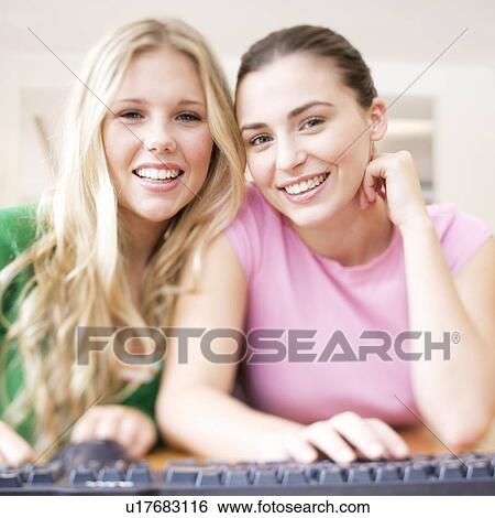 Two teenage girls using a computer View Large Photo Image Stock Photograph - Two teenage girls using a computer. Fotosearch