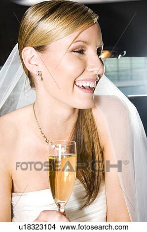 Picture - A bride sitting in the back of a car. Fotosearch