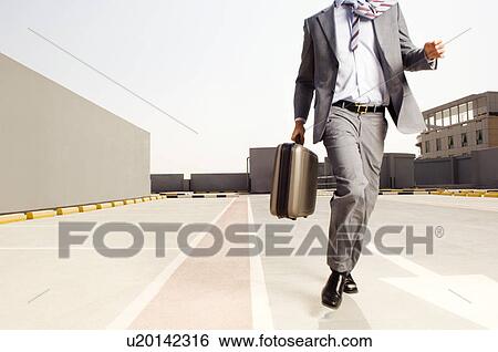 A businessman running View Large Photo Image Stock Photograph - A businessman running. Fotosearch