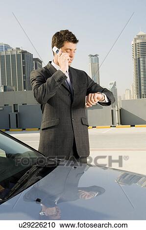 A businessman talking on a mobile phone View Large Photo Image Stock Image - A businessman talking on a mobile phone. Fotosearch
