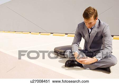 A businessman using a mobile phone View Large Photo Image Stock Image - A businessman using a mobile phone. Fotosearch