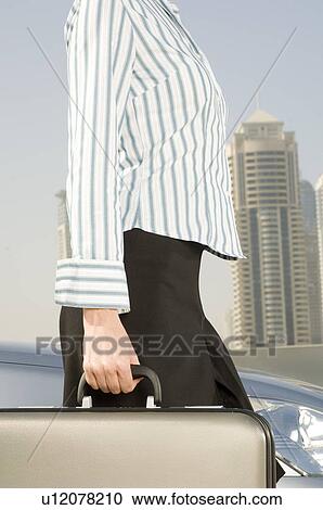 A businesswoman carrying a briefcase View Large Photo Image Stock Image - A businesswoman carrying a briefcase. Fotosearch