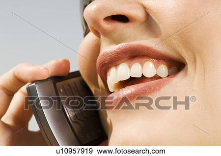 Stock Photo - A businesswoman talking on a mobile phone. Fotosearch