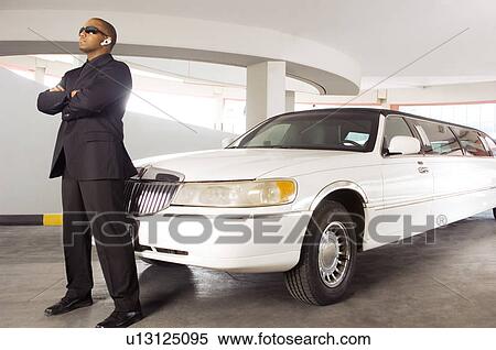 A chauffer standing by a stretch limousine View Large Photo Image Stock Photography - A chauffer standing by a stretch limousine. Fotosearch