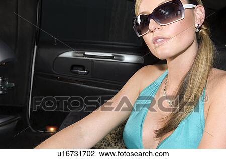 Stock Image - A woman in a stretch limousine. Fotosearch