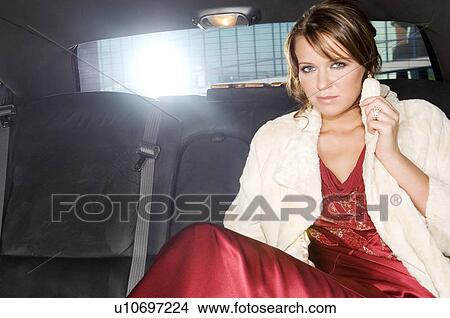 A woman sitting in the back of a car View Large Photo Image Picture - A woman sitting in the back of a car. Fotosearch