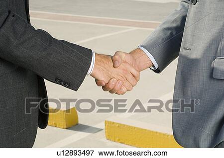 Two businessmen shaking hands View Large Photo Image Stock Photo - Two businessmen shaking hands. Fotosearch