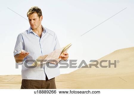 Stock Photograph - A man reading a map. Fotosearch
