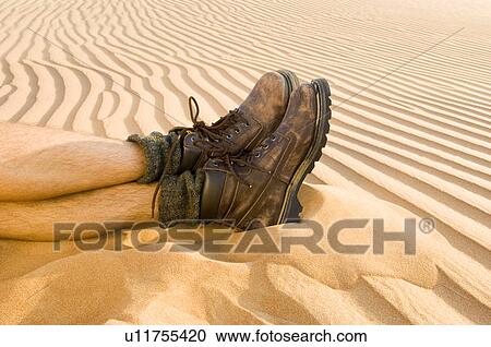 Stock Image - A pair of feet in the desert. Fotosearch
