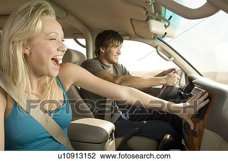 Stock Image - A young couple in a car. Fotosearch