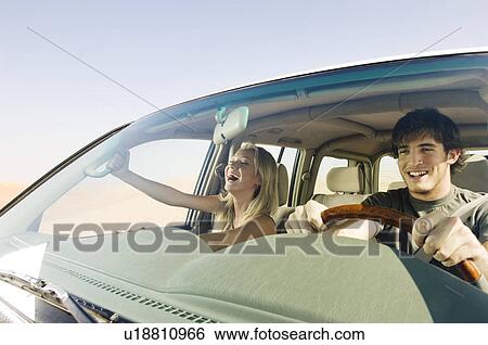 Stock Photograph - A young couple in a car. Fotosearch