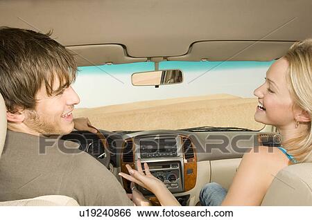 Stock Photograph - A young couple in a car. Fotosearch
