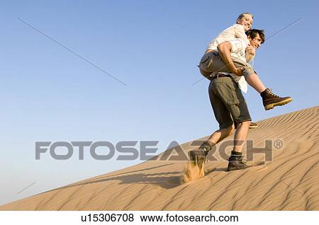 Stock Photo - A young couple in the desert. Fotosearch