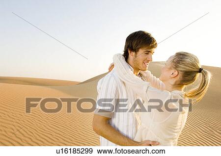 A young couple in the desert View Large Photo Image Stock Photo - A young couple in the desert. Fotosearch