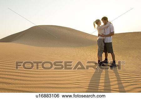 Stock Photograph - A young couple in the desert. Fotosearch