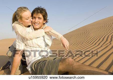 A young couple sitting in the desert View Large Photo Image Stock Image - A young couple sitting in the desert. Fotosearch