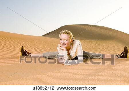 A young woman sitting in the desert View Large Photo Image Stock Image - A young woman sitting in the desert. Fotosearch