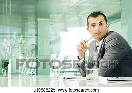 A businessman in a boardroom View Large Photo Image Stock Photography - A businessman in a boardroom. Fotosearch