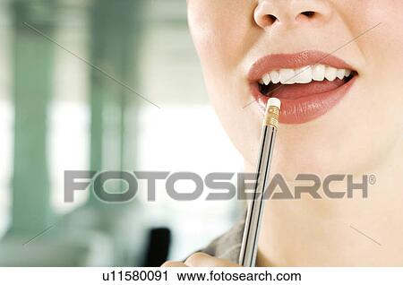 A businesswoman holding a pencil View Large Photo Image Stock Image - A businesswoman holding a pencil. Fotosearch