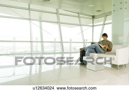 A man with a suitcase waiting in a lobby View Large Photo Image Picture - A man with a suitcase waiting in a lobby. Fotosearch