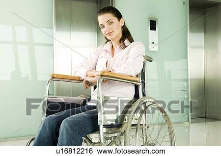 A woman sitting in a wheelchair View Large Photo Image Stock Photograph - A woman sitting in a wheelchair. Fotosearch