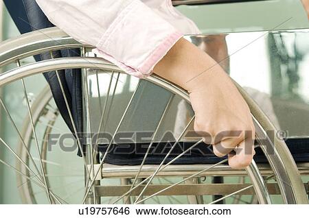 A woman sitting in a wheelchair View Large Photo Image Stock Photograph - A woman sitting in a wheelchair. Fotosearch