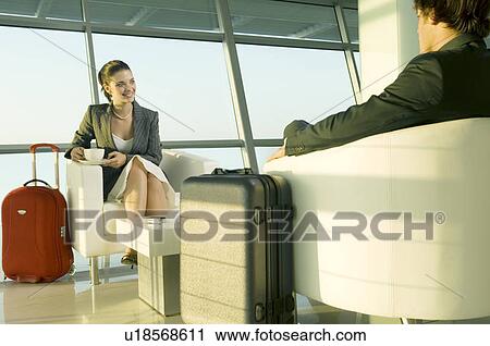 Two travellers at an airport View Large Photo Image Stock Image - Two travellers at an airport. Fotosearch