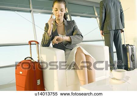 Two travellers at an airport View Large Photo Image Stock Photography - Two travellers at an airport. Fotosearch