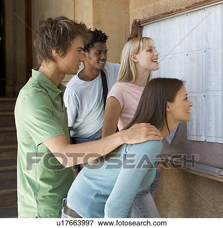 A group of students checking their exam results View Large Photo Image Stock Photo - A group of students checking their exam results. Fotosearch