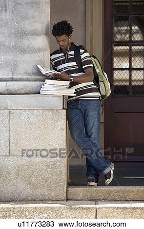 A student carrying a pile of books View Large Photo Image Stock Image - A student carrying a pile of books. Fotosearch