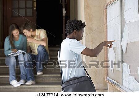Picture - A student checking his exam results. Fotosearch