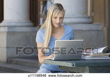 A student using a laptop computer View Large Photo Image Stock Photo - A student using a laptop computer. Fotosearch