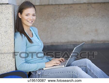 Stock Photo - A student using a laptop computer. Fotosearch