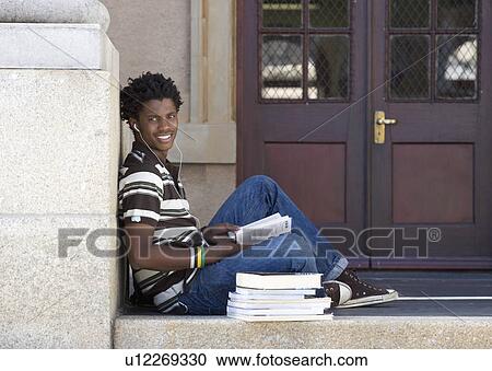 A student with a pile of books View Large Photo Image Stock Image - A student with a pile of books. Fotosearch