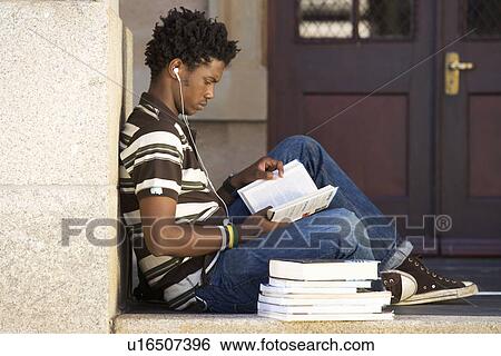 A student with a pile of books View Large Photo Image Stock Photograph - A student with a pile of books. Fotosearch