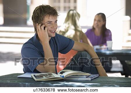 Stock Photo - A university student chatting on a mobile phone. Fotosearch