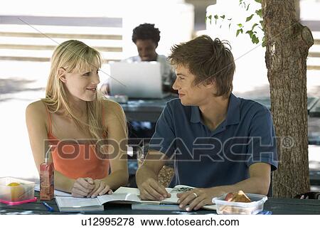 Two university students helping each other with revision View Large Photo Image Stock Photo - Two university students helping each other with revision. Fotosearch
