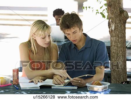 Two university students helping each other with revision View Large Photo Image Stock Photo - Two university students helping each other with revision. Fotosearch