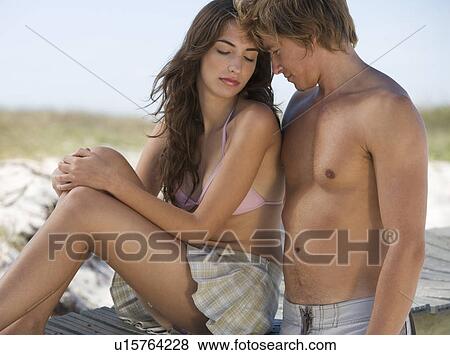 A young couple on a beach View Large Photo Image Stock Photo - A young couple on a beach. Fotosearch