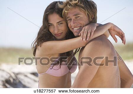 A young couple on a beach View Large Photo Image Stock Photo - A young couple on a beach. Fotosearch