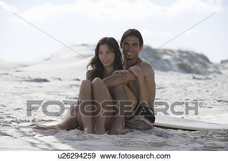 Stock Photo - A young couple on a beach. Fotosearch