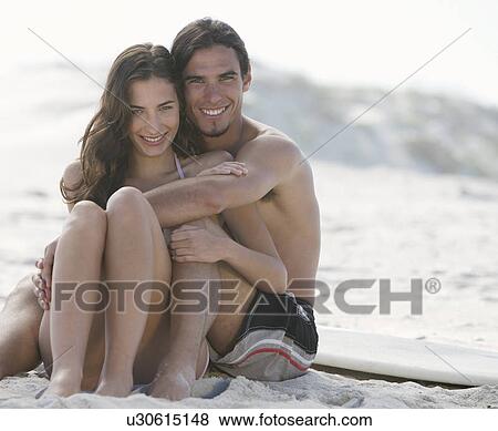 A young couple on a beach View Large Photo Image Stock Photo - A young couple on a beach. Fotosearch