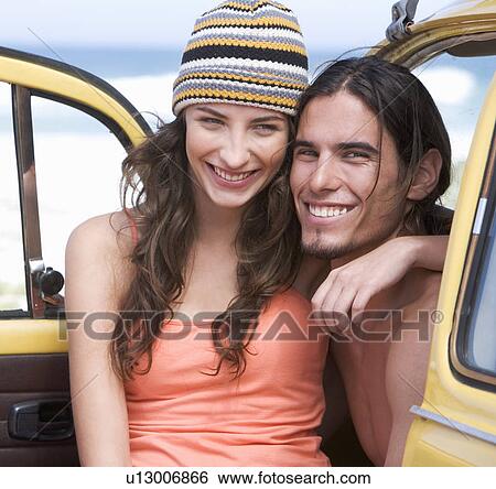 A young couple on a beach View Large Photo Image Stock Photograph - A young couple on a beach. Fotosearch