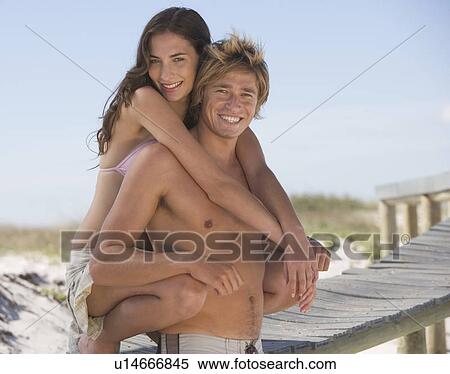 A young couple on a beach View Large Photo Image Stock Photography - A young couple on a beach. Fotosearch