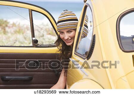 A young woman sitting in a car View Large Photo Image Stock Photo - A young woman sitting in a car. Fotosearch