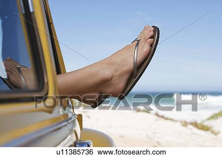 A young woman sitting in a car View Large Photo Image Stock Photograph - A young woman sitting in a car. Fotosearch