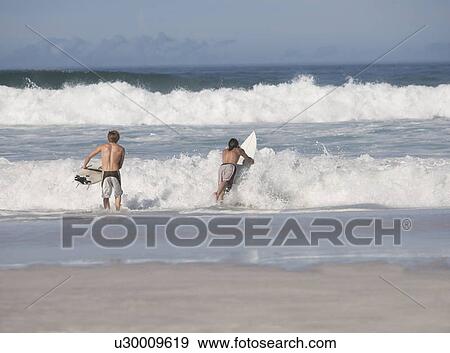 Two surfers View Large Photo Image Stock Photo - Two surfers. Fotosearch