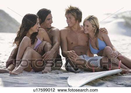 Stock Image - Two young couples on a beach. Fotosearch