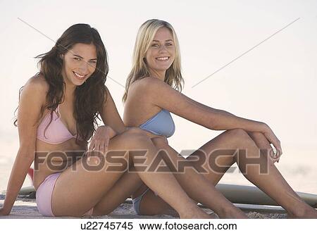 Stock Photography - Two young women in bikinis. Fotosearch